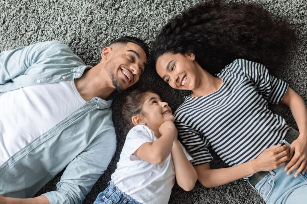 Family laying on new carpet from Bradley Floorings of Augusta, GA